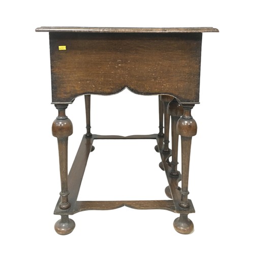 153 - A William and Mary style lowboy, with three drawers, shaped apron raised upon six turned legs with p... 