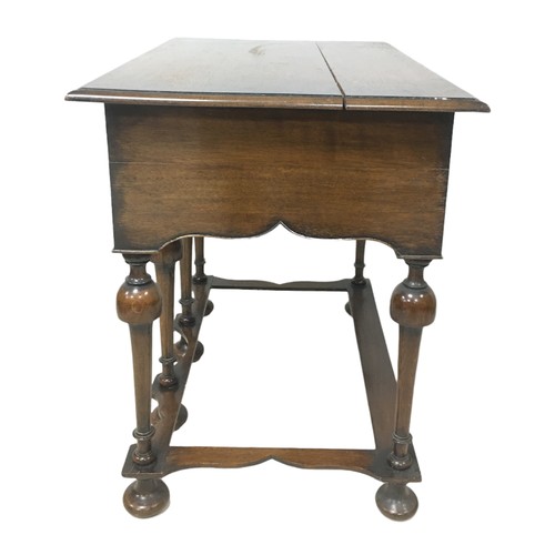 153 - A William and Mary style lowboy, with three drawers, shaped apron raised upon six turned legs with p... 