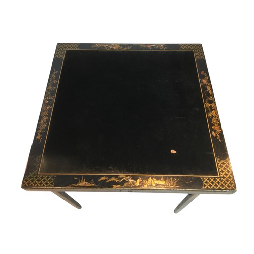 141A - A Chinoiserie folding card table, with inlaid fabric top, bordered by decorative lacquered design wi... 