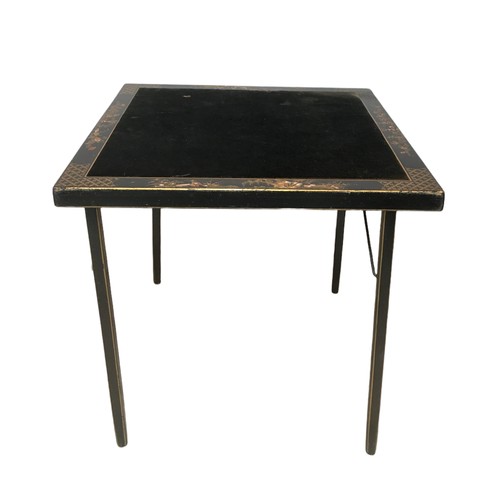 141A - A Chinoiserie folding card table, with inlaid fabric top, bordered by decorative lacquered design wi... 