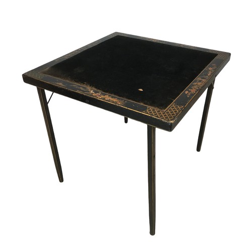 141A - A Chinoiserie folding card table, with inlaid fabric top, bordered by decorative lacquered design wi... 