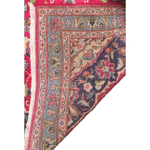 172 - A Kashan rug, with a central caucasian lozenge with blue border within a red ground, 203 by 117cm.