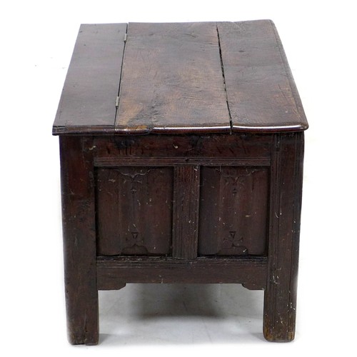 197 - A 17th century oak chest, the three panel front carved with decorative carving, raised on stile feet... 