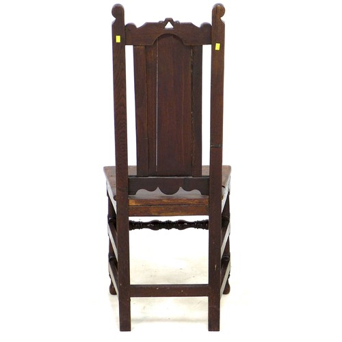 184 - A 17th century oak side chair, with scroll finials and solid seat, raised on turned supports with kn... 