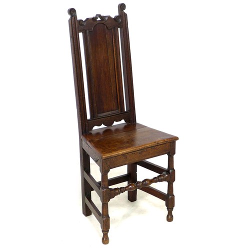 184 - A 17th century oak side chair, with scroll finials and solid seat, raised on turned supports with kn... 