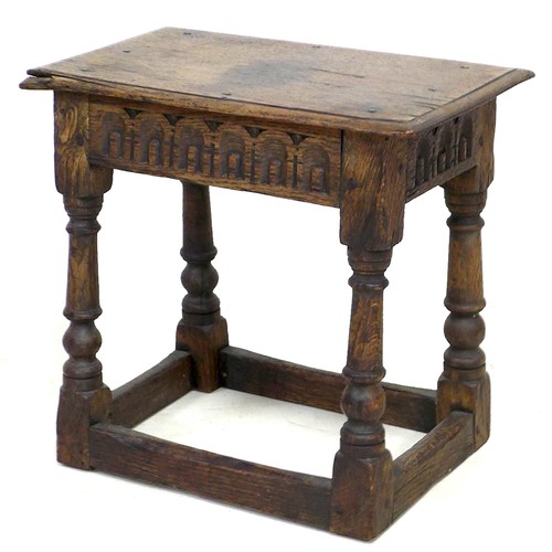 167 - An early 18th century oak stool, carved frieze, solid seat raised on turned legs joined by periphera... 