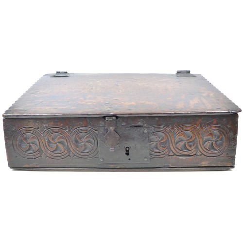 213 - A 17th century oak bible box / desk, the front carved with a continuous guilloche style frieze, iron... 