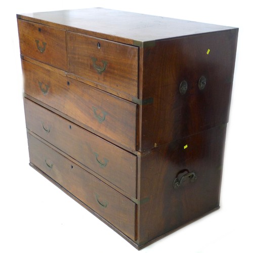 198 - An early Victorian mahogany campaign chest of two short over three long drawers, flush campaign bras... 