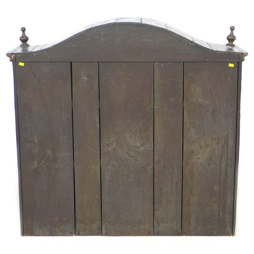 199 - An 18th century oak cupboard, with arched moulded cornice, turned finials, two doors enclosing two s... 