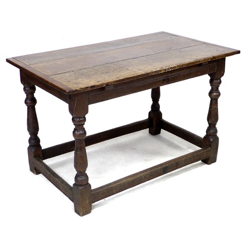 207 - A 17th century oak table, three plank rectangular top with breadboard ends, channelled freeze, raise... 