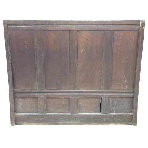 216 - A 17th century oak box settle, with four panel back decoratively carved foliate and lunette frieze, ... 