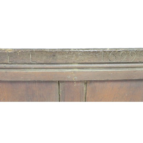 216 - A 17th century oak box settle, with four panel back decoratively carved foliate and lunette frieze, ... 