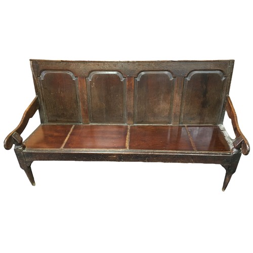 206 - A George III oak settle, with four fielded panels, open shaped arms, replacement seat, raised on squ... 