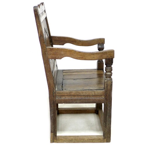 201 - A late 17th century oak Wainscot chair, with open shaped arms, later solid seat, single (split) pane... 