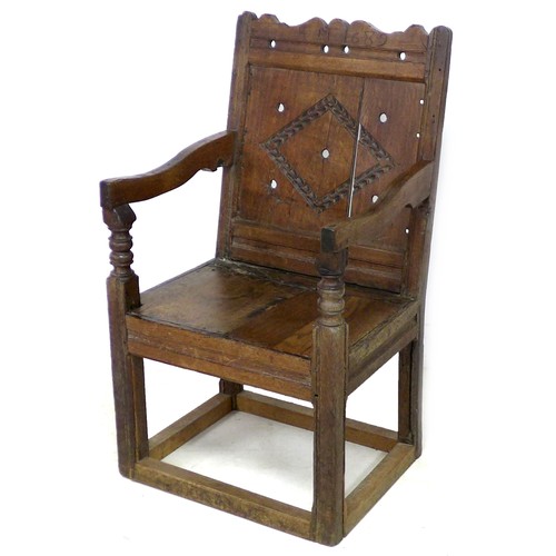 201 - A late 17th century oak Wainscot chair, with open shaped arms, later solid seat, single (split) pane... 