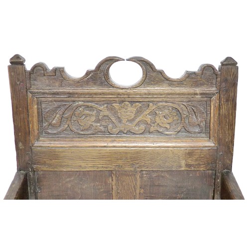 202 - A late 17th century oak Wainscot chair, with open shaped arms, later solid seat, three panel back, t... 