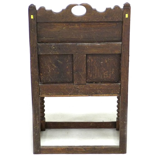 202 - A late 17th century oak Wainscot chair, with open shaped arms, later solid seat, three panel back, t... 