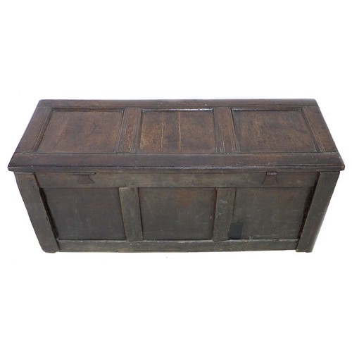 193 - A 17th century oak chest, three panel front with chip carved border above and guilloche carved borde... 