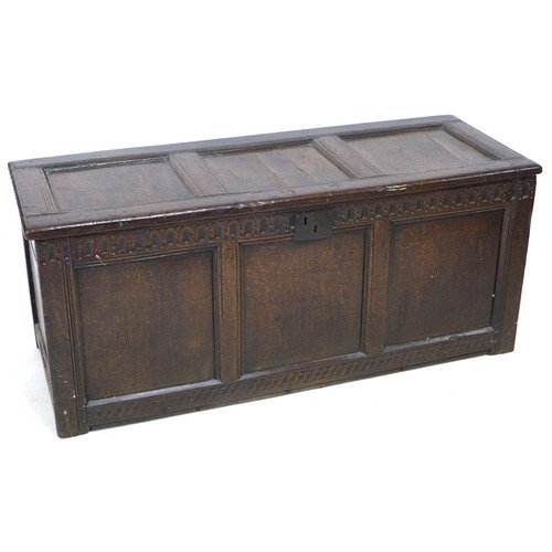 193 - A 17th century oak chest, three panel front with chip carved border above and guilloche carved borde... 