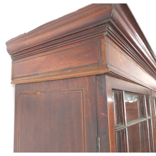 214 - A George III mahogany bookcase, twin astragal glazed doors enclosing four adjustable shelves, below ... 