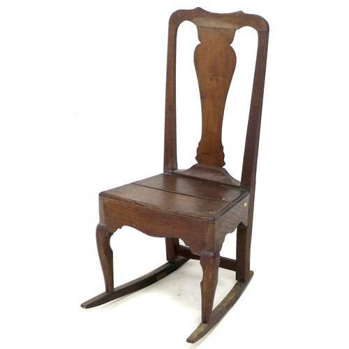 165 - An 18th century oak rocking chair, with shaped top rail, urn form back slat, solid seat, raised upon... 