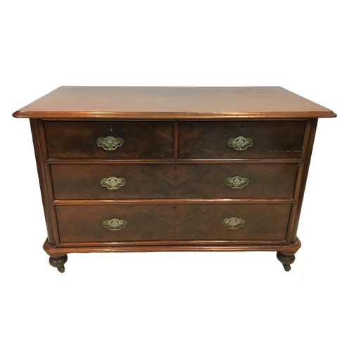 154 - An early 20th century mahogany chest of two over two drawers, with turned legs raised upon casters, ... 