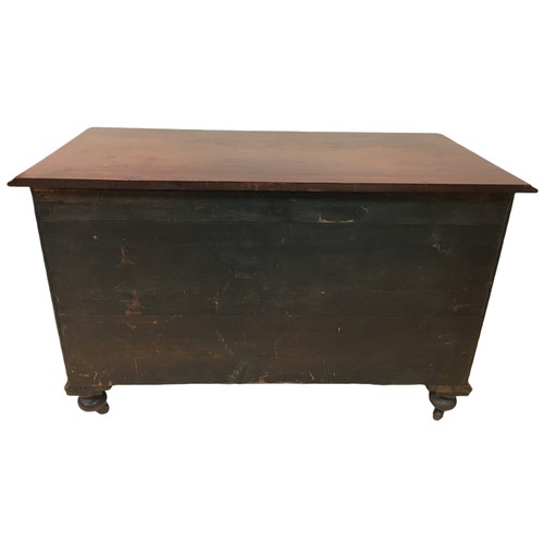 154 - An early 20th century mahogany chest of two over two drawers, with turned legs raised upon casters, ... 