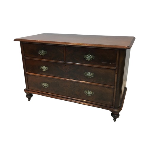 154 - An early 20th century mahogany chest of two over two drawers, with turned legs raised upon casters, ... 