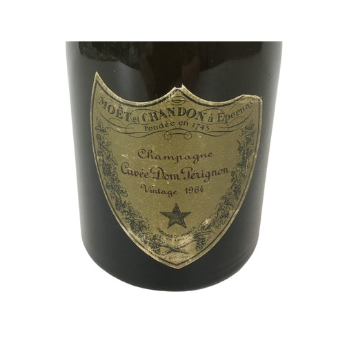 99 - Vintage champagne, a bottle of Moet & Chandon Cuvee Dom Perignon, vintage 1964, U: mid-shoulder, lab... 