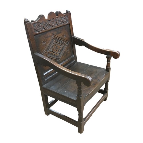 211 - A 17th century oak Wainscot chair, with open scroll end arms, later solid seat, single panel back ca... 