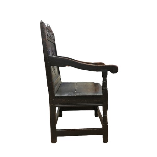 211 - A 17th century oak Wainscot chair, with open scroll end arms, later solid seat, single panel back ca... 