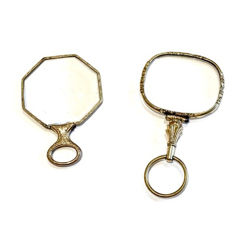 45 - Two Georgian yellow metal eyeglasses, each with , chased and engraved decoration. (2)