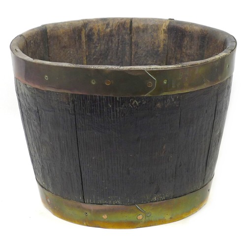 55 - A brass-bound fire bucket, 38 by 38.5 by 28.5 cm high.