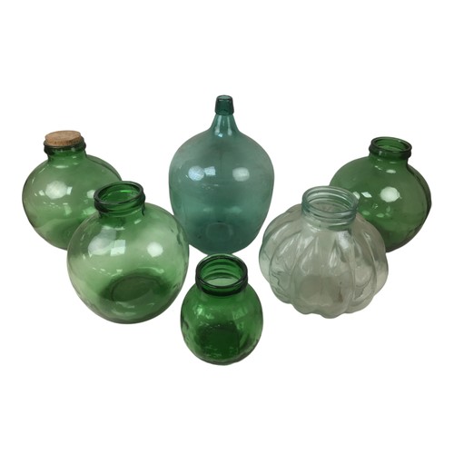 18 - Six early 20th century and later glass carboys, the largest a green carboy, 49cm high. (6)