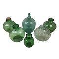 Six early 20th century and later glass carboys, the largest a green carboy, 49cm high. (6)