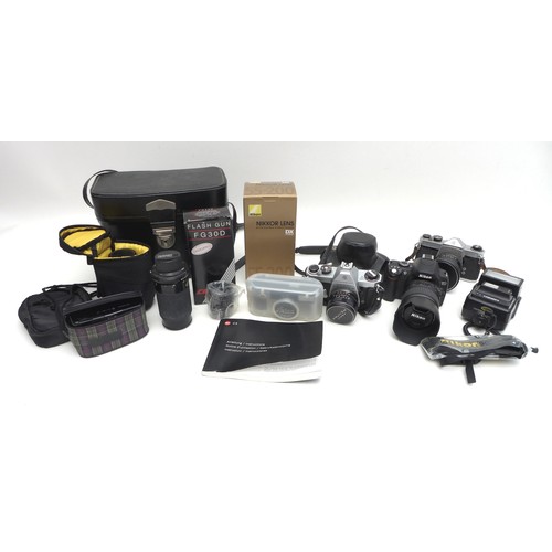 33 - A collection of cameras and lenses, including a modern Leica C3 camera together with Praktika and Mi... 