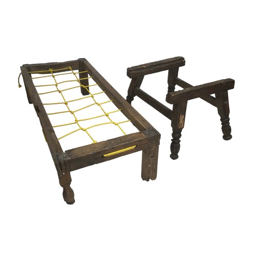 151 - A 17th century oak small bed frame, with modern rope base, with three style legs and one turned leg,... 