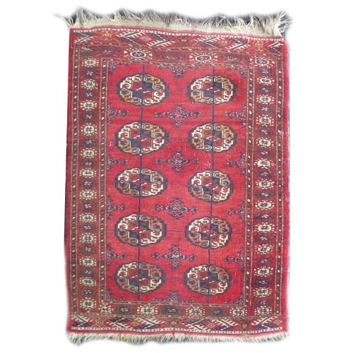 162 - Two mid 20th century rugs, comprising a  with red ground woollen rug with ten circular lozenges to i... 