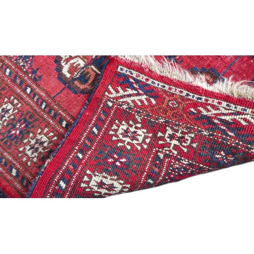 162 - Two mid 20th century rugs, comprising a  with red ground woollen rug with ten circular lozenges to i... 