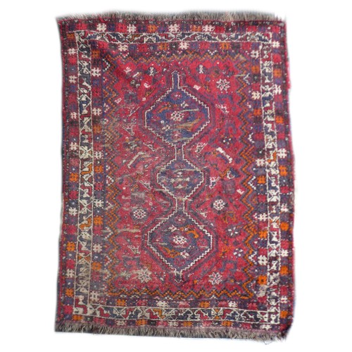 162 - Two mid 20th century rugs, comprising a  with red ground woollen rug with ten circular lozenges to i... 