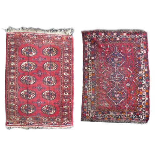 162 - Two mid 20th century rugs, comprising a  with red ground woollen rug with ten circular lozenges to i... 