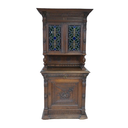 186 - A Flemish 19th century carved oak cabinet, with carved cornice and lions head mounts, the top sectio... 