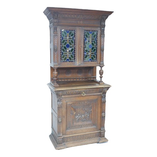 190 - A Flemish 19th century carved oak cabinet, with carved cornice and lions head mounts, the top sectio... 