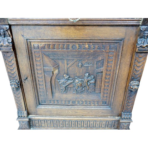 190 - A Flemish 19th century carved oak cabinet, with carved cornice and lions head mounts, the top sectio... 