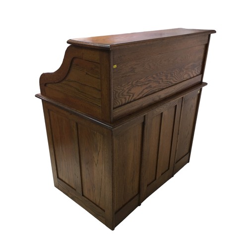 183 - An Edwardian oak roll top desk, fitted with an arrangement of small drawers and pigeon holes behind ... 