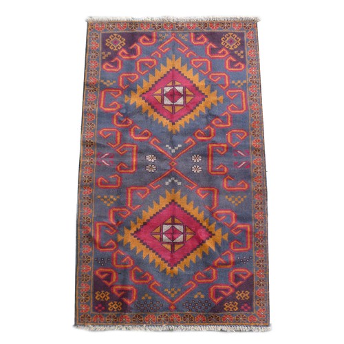 169 - A new Baluchi rug, with two central medallions, with repeating floral border, 144 by 86cm.