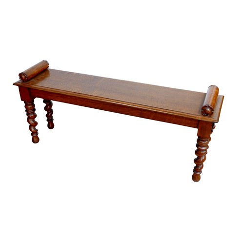 176 - An early 20th century oak window seat, with carved  decoration to its cylindrical arms, raised upon ... 