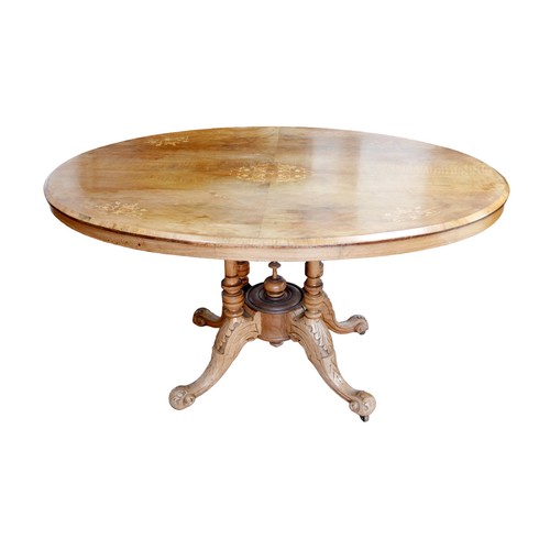 161 - A 19th century oval walnut  breakfast table, raised upon a quatre-form base with cabriole legs termi... 