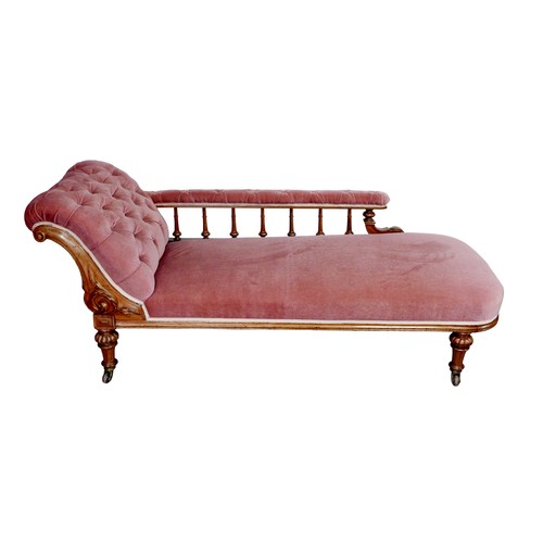 173 - An Edwardian chaise longue, with mahogany frame and pink upholstery, button back, raised upon turned... 