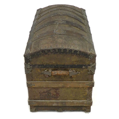 170 - A 20th century dome topped storage chest, with wooden supports and embossed with metal decorative ap... 